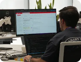 Persona trabajando frente a monitores en una oficina de Bluetab